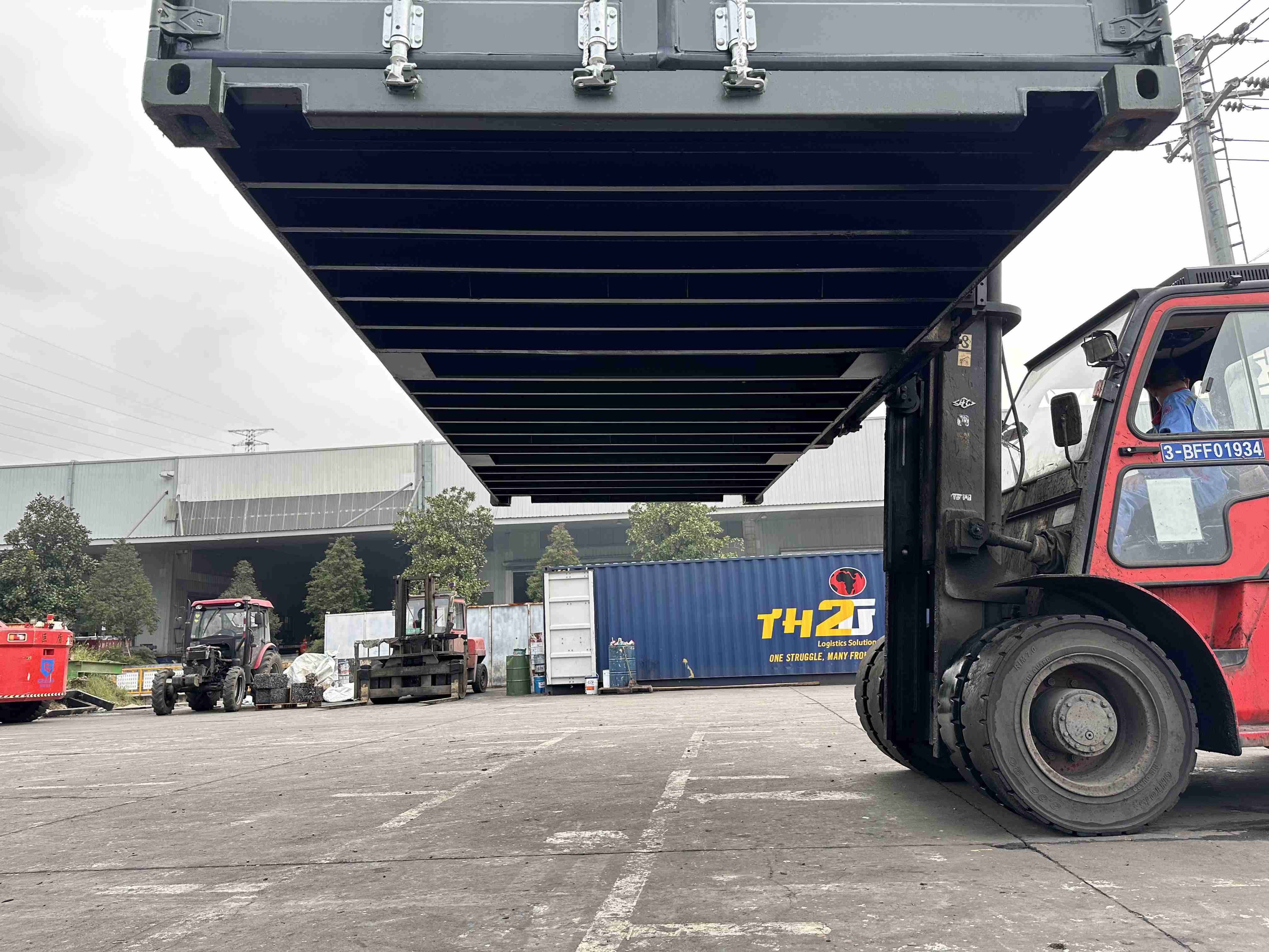 container being moved on a lift