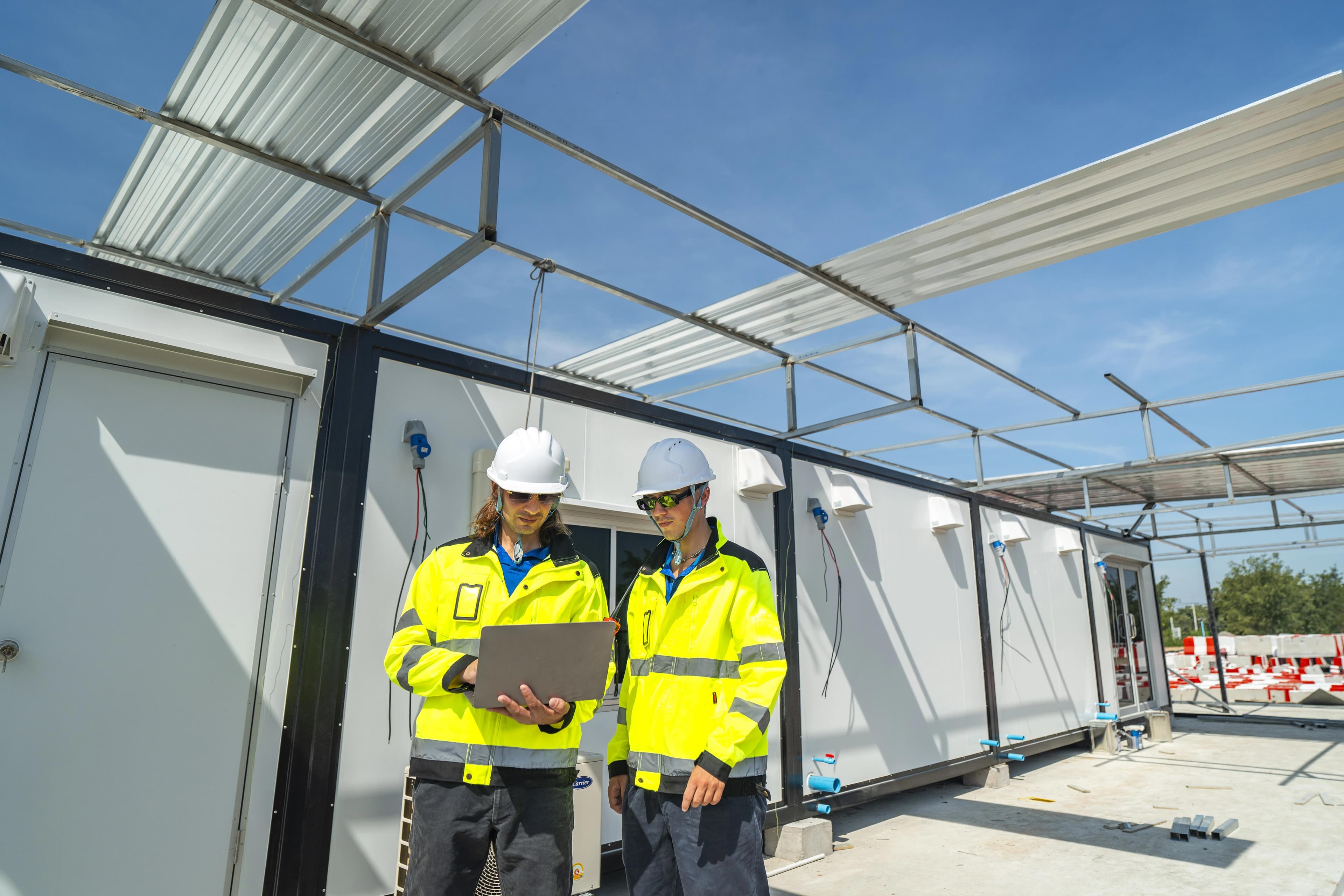 construction workers outside a site container office